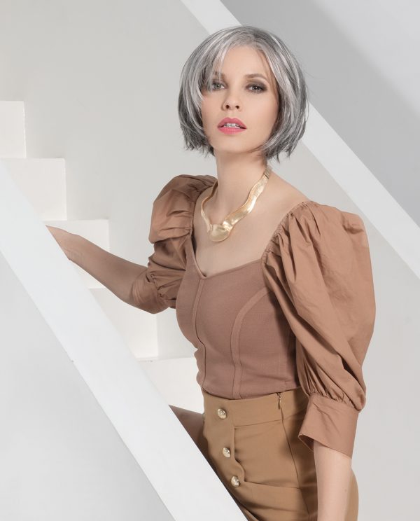 Model wearing short grey/white wig.