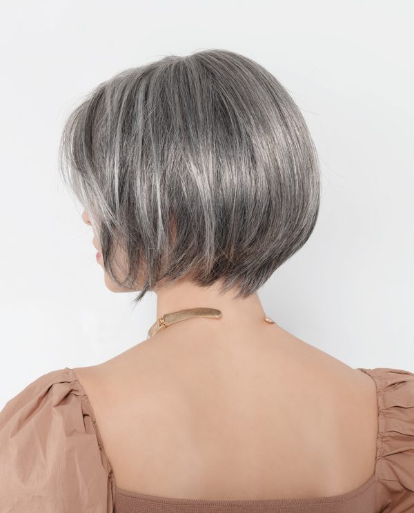 Model wearing short grey wig.